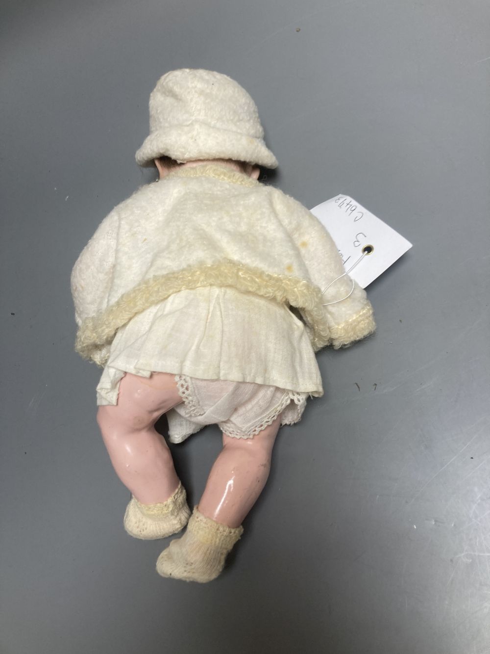An Armand Marseille bisque boy doll, mould 990 with fixed glass eyes, 30cm, a bisque doll with jointed composition body, 47cm and a pai